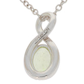 Oval green peridot pendant in polished 14K yellow gold setting with diamond accent, elegant necklace design.